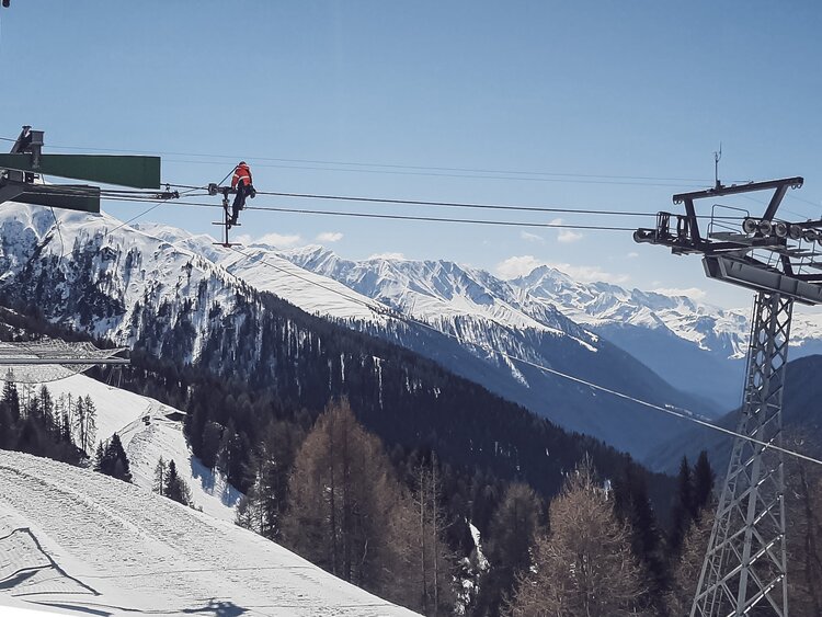 Ein Mitarbeiternder spannt das Förderseil der Rinerhornbahn bei der Bergstation ab.  | © Davos Klosters Mountains