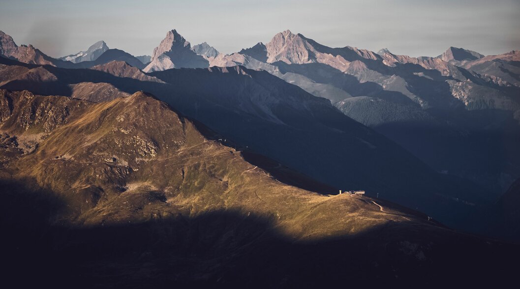 Blick in Richtung Rinerhorn, mit der von der Sonne beleuchteten Hubelhütte, das Tinzenhorn im Hintergrund. | © Davos Klosters Mountains