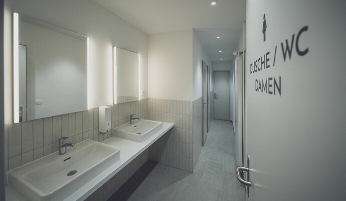 2 Waschbecken mit Spiegel und Durchgang zu den Toiltetten | © Davos Klosters Mountains 