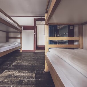 Mehrbettzimmer mit Stockbetten und Waschbecken  | © Davos Klosters Mountains 