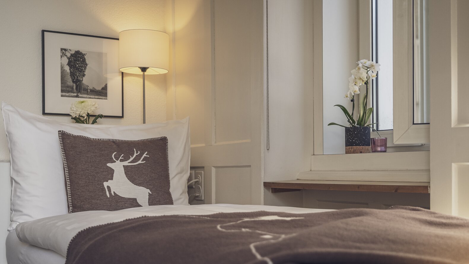 Bett mit brauner Tagesdecke | © Davos Klosters Mountains