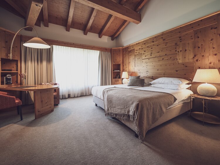 Grosszügiges Doppelbettzimmer komplett mit Holz ausgestattet | © Davos Klosters Mountains 